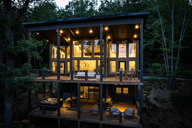 back of property with a wooden deck