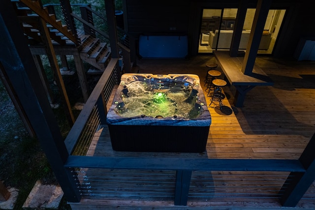 exterior space featuring an outdoor hot tub and stairs