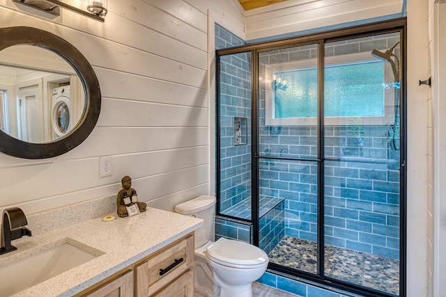 full bathroom with wooden walls, vanity, a shower stall, and toilet
