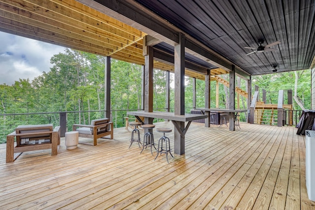wooden terrace featuring outdoor dry bar, stairs, and a ceiling fan