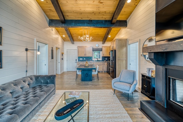living room featuring wood ceiling, wood finished floors, wooden walls, and a chandelier