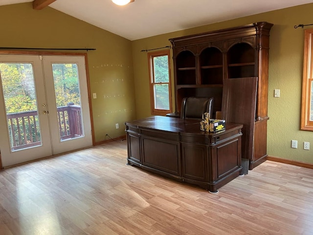 office featuring french doors, lofted ceiling with beams, light wood-type flooring, and plenty of natural light