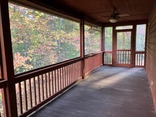 unfurnished sunroom featuring ceiling fan