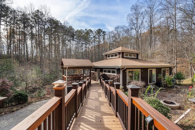 rear view of house featuring an outdoor fire pit