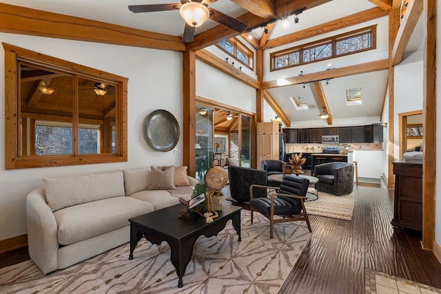 living room with ceiling fan, lofted ceiling with beams, and light hardwood / wood-style floors