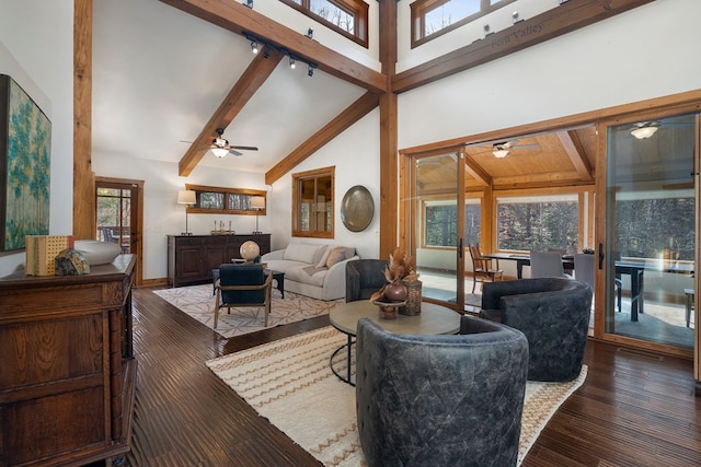 living room featuring beamed ceiling, plenty of natural light, dark wood-type flooring, and high vaulted ceiling