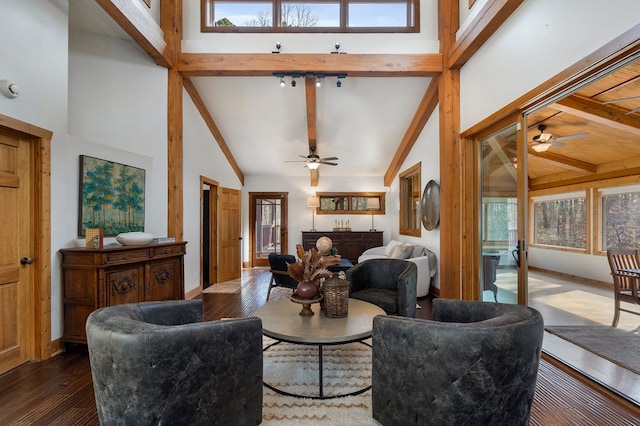 living room featuring beamed ceiling, ceiling fan, a healthy amount of sunlight, and dark hardwood / wood-style flooring