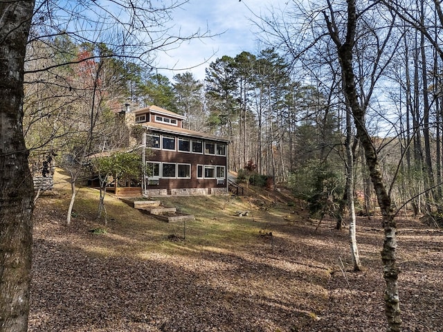 rear view of property featuring a sunroom