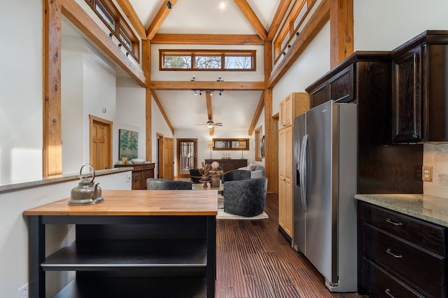 kitchen with ceiling fan, beamed ceiling, wooden counters, and stainless steel refrigerator with ice dispenser