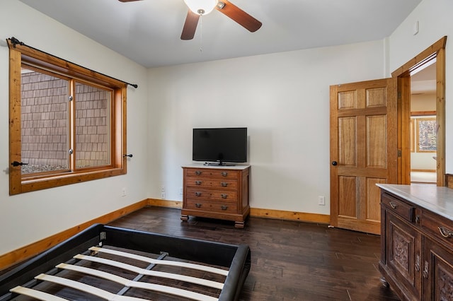 bedroom with dark hardwood / wood-style floors and ceiling fan