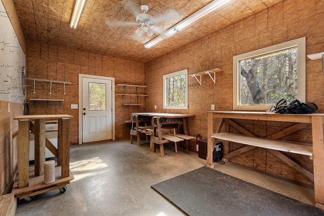 misc room featuring a wealth of natural light, ceiling fan, and concrete flooring