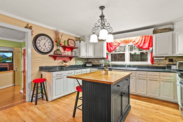 101 Harper Vly, Ellijay, GA 30540 - kitchen featuring butcher block counters, ornamental molding, a kitchen breakfast bar, backsplash, and a chandelier