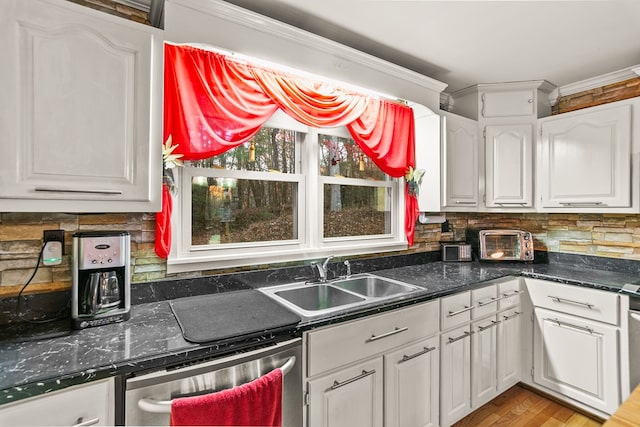 kitchen featuring white cabinetry, sink, dishwasher, light hardwood / wood-style flooring, and crown molding