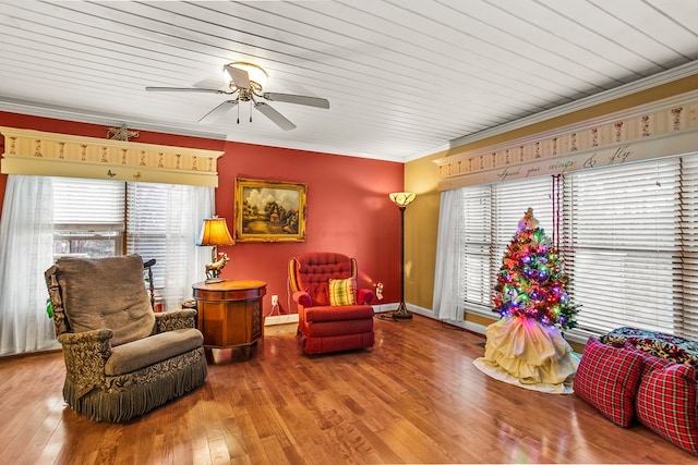 sitting room with hardwood / wood-style flooring, a healthy amount of sunlight, and crown molding