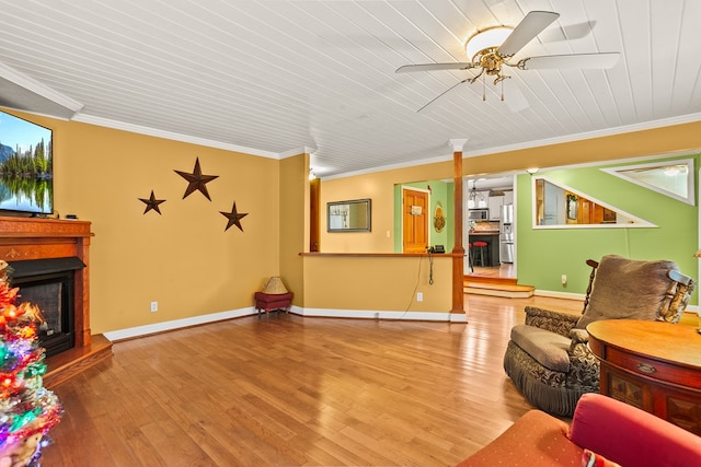 101 Harper Vly, Ellijay, GA 30540 - living area featuring a warm lit fireplace, wood finished floors, ceiling fan, ornamental molding, and wood ceiling