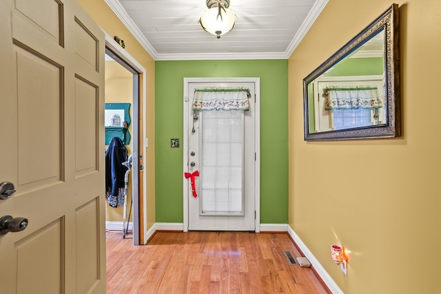 entryway with crown molding and light hardwood / wood-style floors