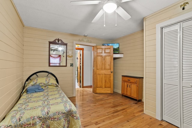 101 Harper Vly, Ellijay, GA 30540 - bedroom with light wood-style flooring, wooden walls, a closet, and ceiling fan