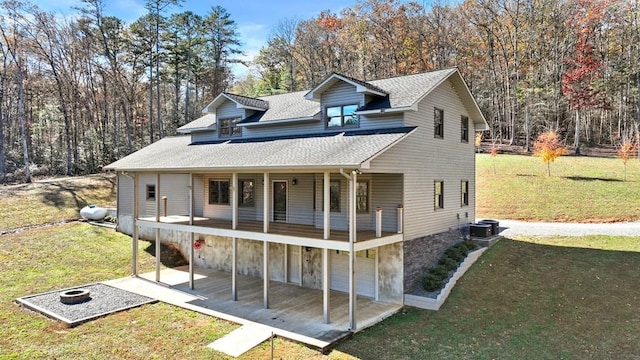 view of front facade with cooling unit and a front yard