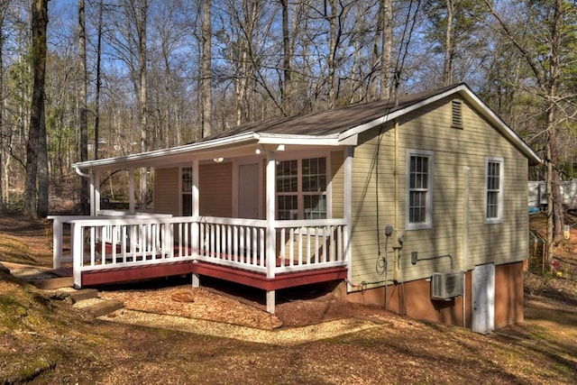 view of front of property featuring a wall mounted air conditioner