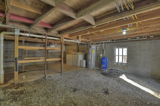 basement featuring electric water heater and separate washer and dryer