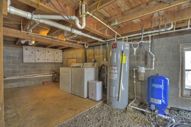 basement with electric water heater and washer and clothes dryer