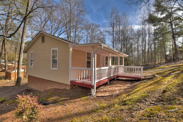 view of side of property featuring covered porch