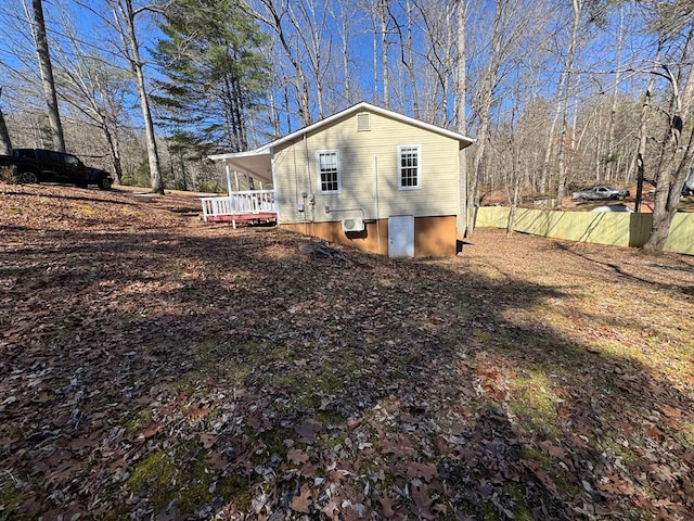 view of side of property featuring covered porch