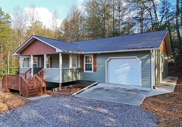 ranch-style house featuring a garage and covered porch