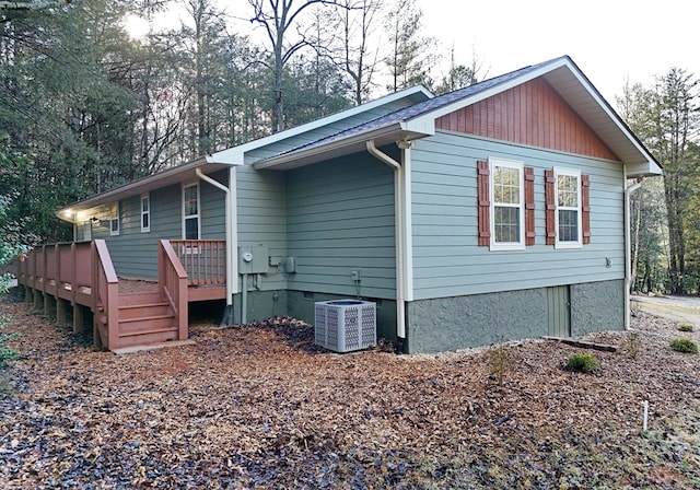 view of home's exterior with central air condition unit and a deck