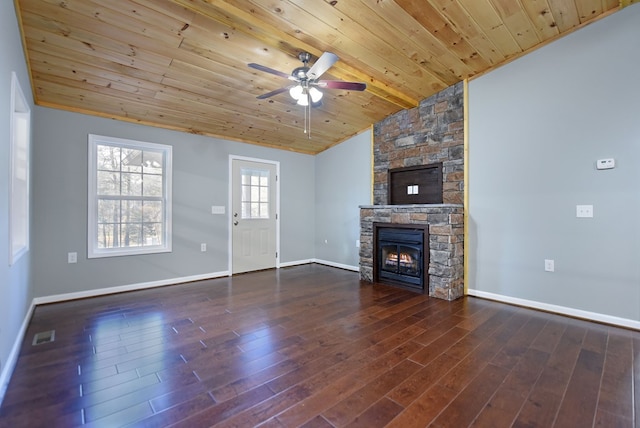 unfurnished living room with vaulted ceiling, a stone fireplace, dark hardwood / wood-style floors, and wooden ceiling