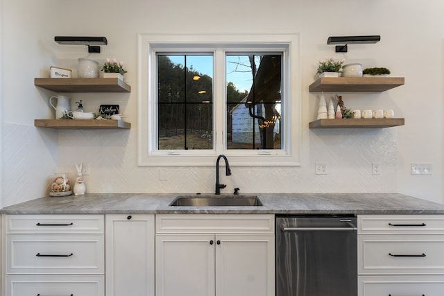 kitchen featuring stainless steel dishwasher, open shelves, white cabinetry, and a sink