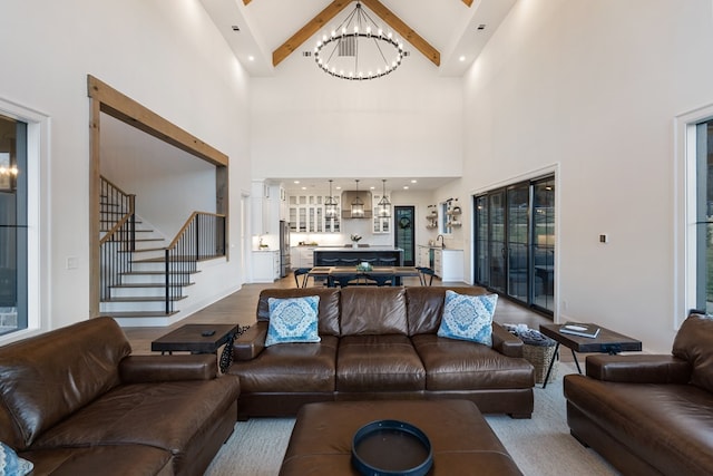 living room with stairway, a notable chandelier, wood finished floors, and vaulted ceiling with beams