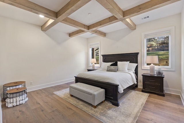 bedroom with beam ceiling, wood finished floors, baseboards, and coffered ceiling