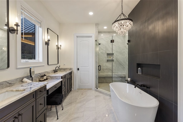 bathroom featuring two vanities, a sink, a freestanding bath, a shower stall, and marble finish floor
