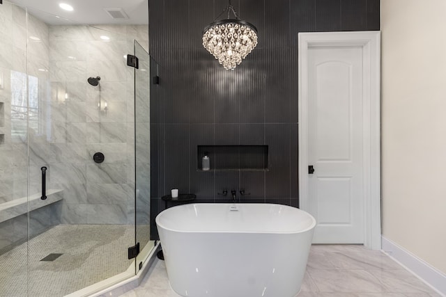 bathroom featuring visible vents, a freestanding bath, a shower stall, a notable chandelier, and marble finish floor