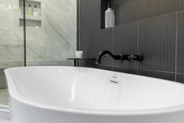 details with a freestanding tub and a sink
