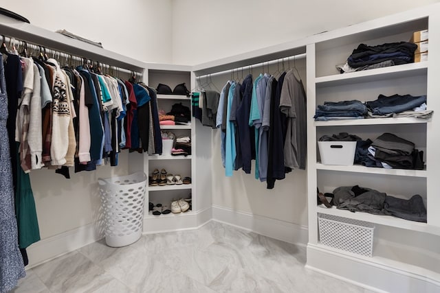 spacious closet featuring marble finish floor