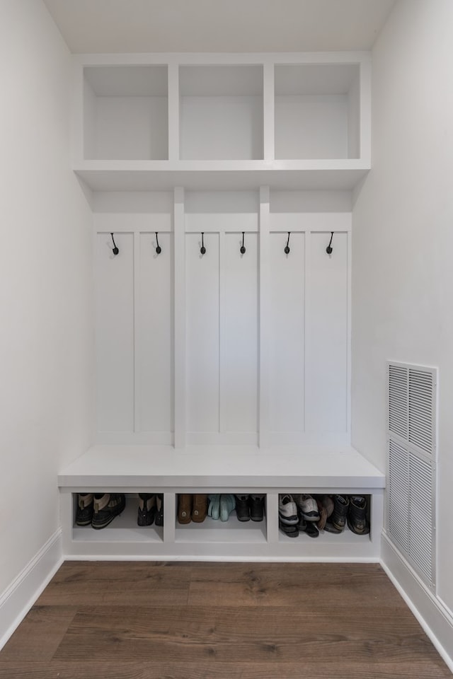 mudroom featuring visible vents, baseboards, and dark wood-style flooring