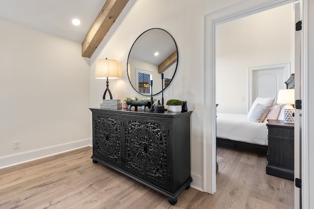 corridor featuring beamed ceiling, recessed lighting, wood finished floors, and baseboards