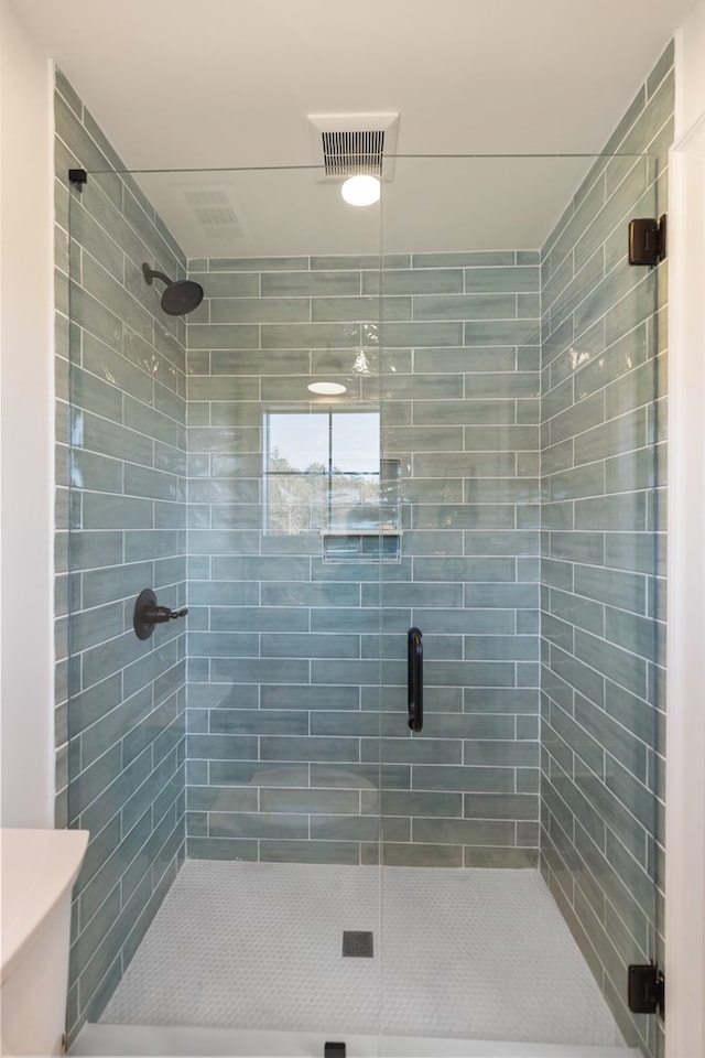 bathroom with visible vents and a stall shower