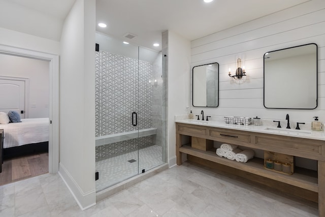 full bathroom with visible vents, a shower stall, marble finish floor, and a sink
