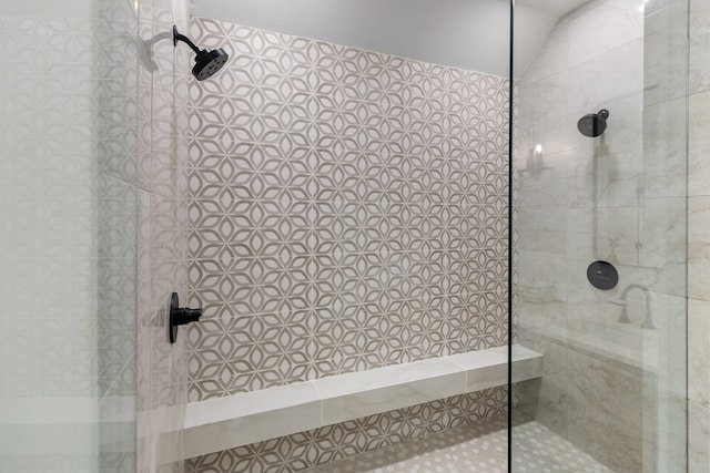 bathroom featuring lofted ceiling and a walk in shower