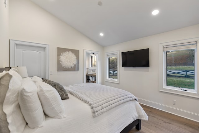 bedroom with vaulted ceiling, recessed lighting, wood finished floors, and baseboards