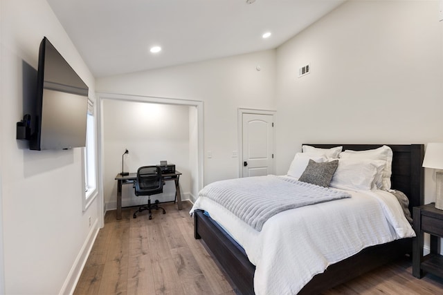 bedroom with recessed lighting, light wood-style flooring, and vaulted ceiling