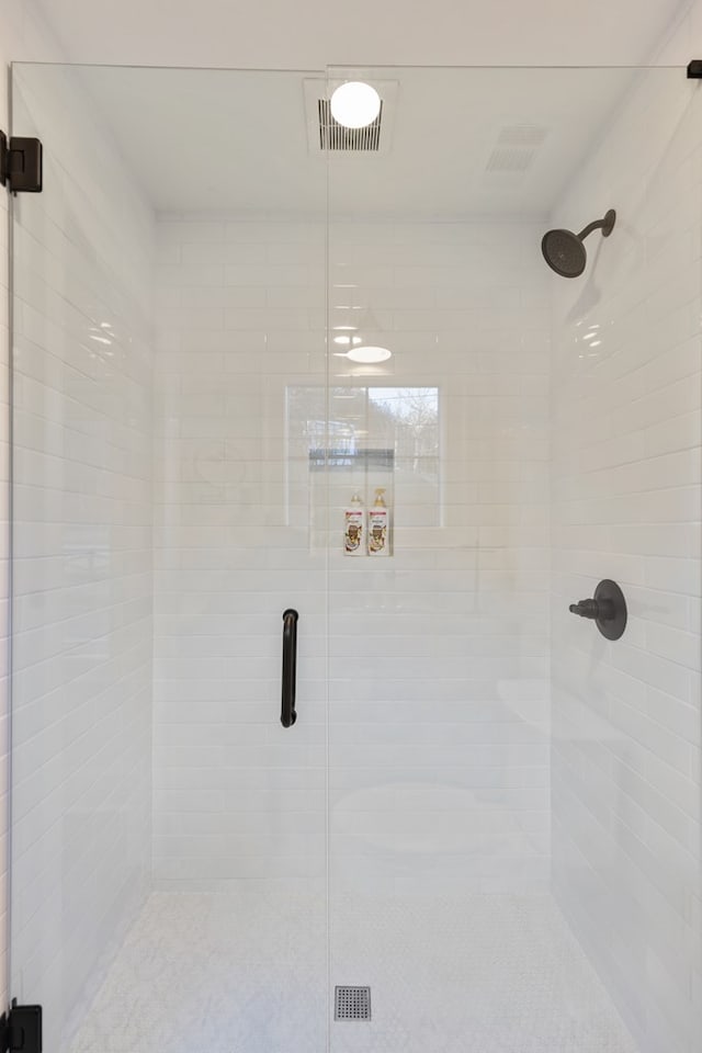 bathroom with visible vents and a stall shower