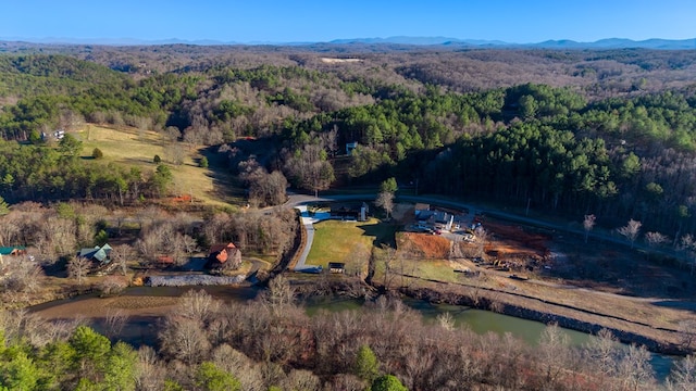 aerial view featuring a forest view and a mountain view