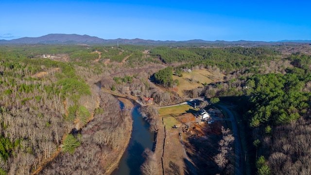aerial view with a mountain view and a wooded view