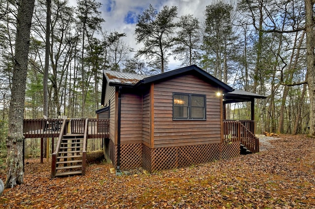 view of home's exterior featuring a wooden deck