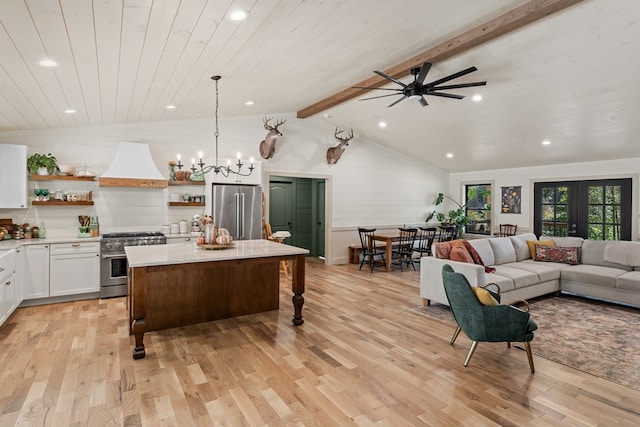 kitchen with custom exhaust hood, white cabinetry, lofted ceiling with beams, decorative light fixtures, and high end appliances