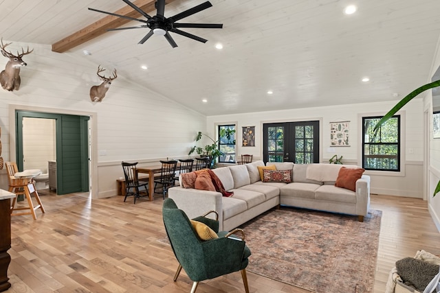 living room with lofted ceiling with beams, light wood-type flooring, and ceiling fan